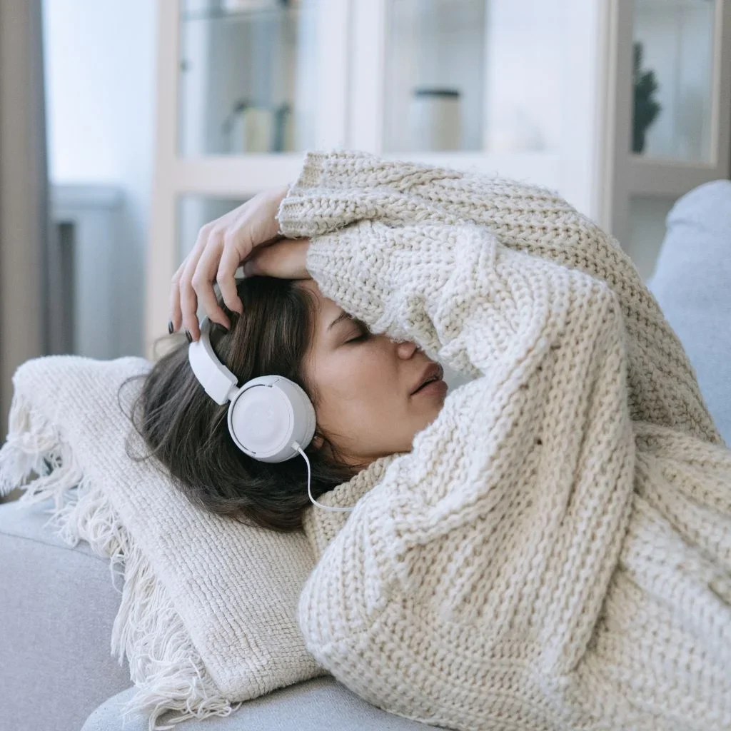 woman receiving ketamine assisted therapy with a headset providing bilateral stimulation