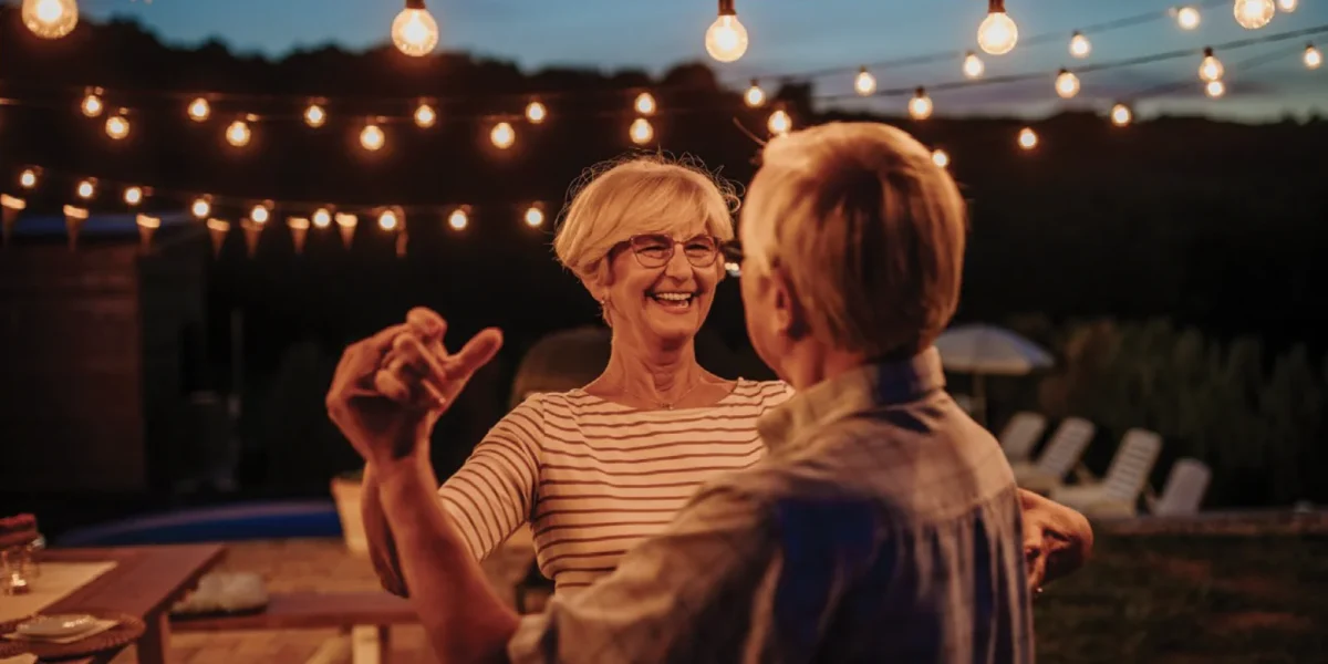 Elderly couple dancing and laughing