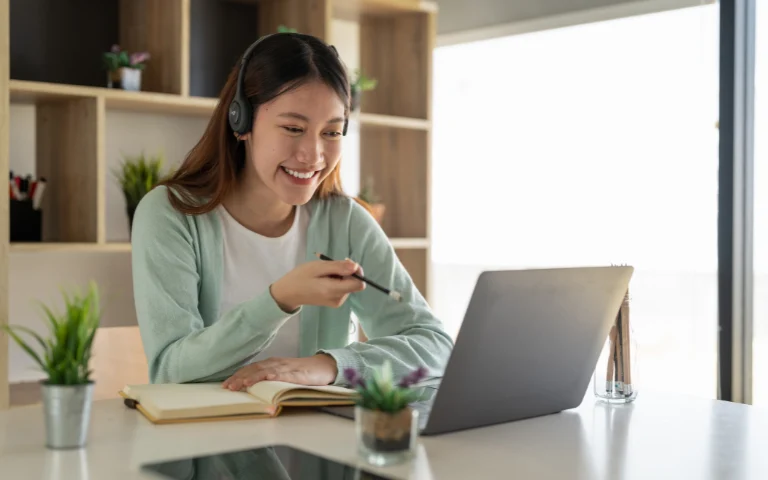 Woman taking notes on insights from online counseling